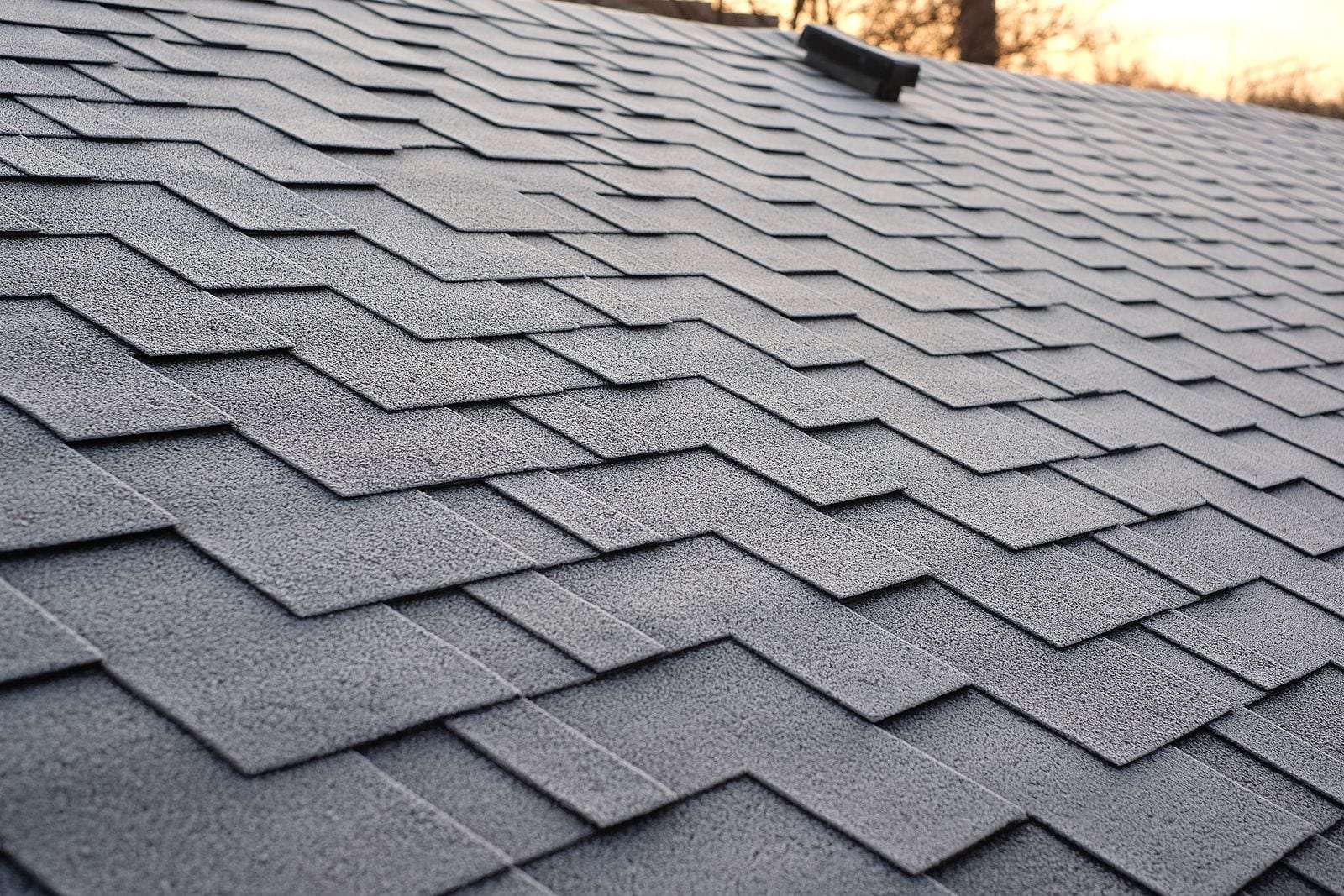 Close-up of grey asphalt shingles on a residential roof